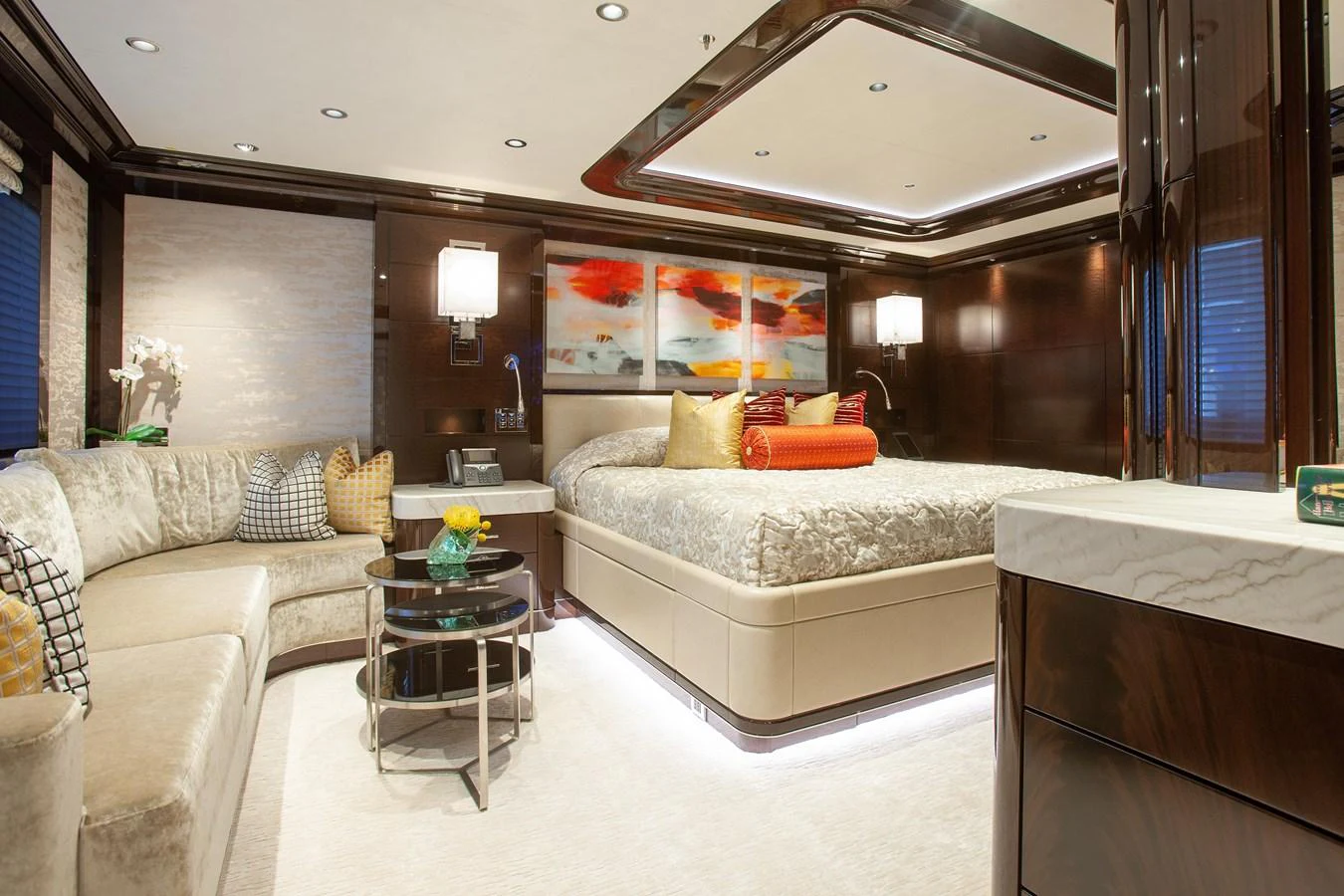 The master stateroom exudes luxury with its plush bedding, elegant decor, and ambient lighting. aboard BOARDWALK V Yacht for Sale