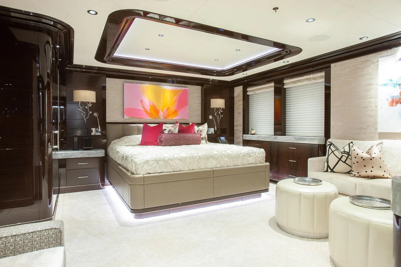 The master stateroom features a luxurious bed with elegant lighting and modern decor. aboard BOARDWALK V Yacht for Sale