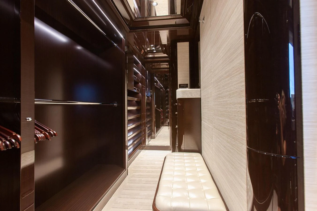 The yacht features a luxurious walk-in closet with ample storage and seating. aboard BOARDWALK V Yacht for Sale