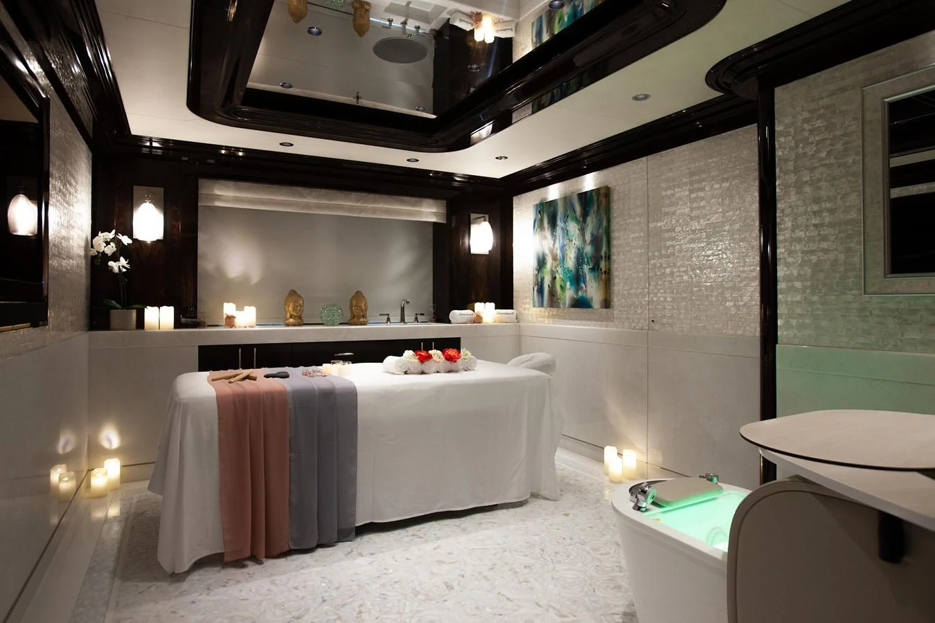 The yacht features a luxurious spa room with a massage table and serene lighting. aboard BOARDWALK V Yacht for Sale