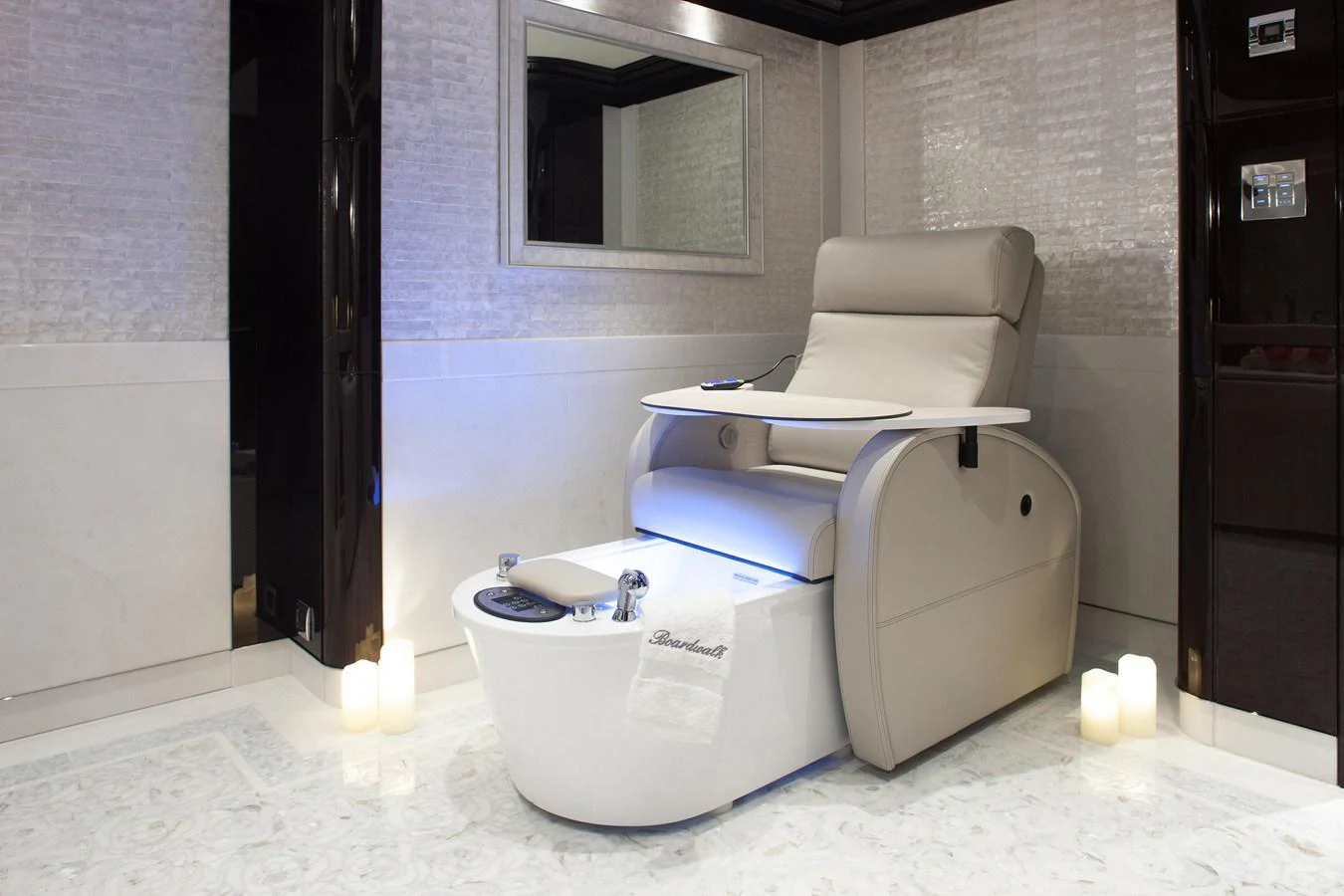 This luxurious spa area features a plush massage chair and soothing ambient lighting. aboard BOARDWALK V Yacht for Sale