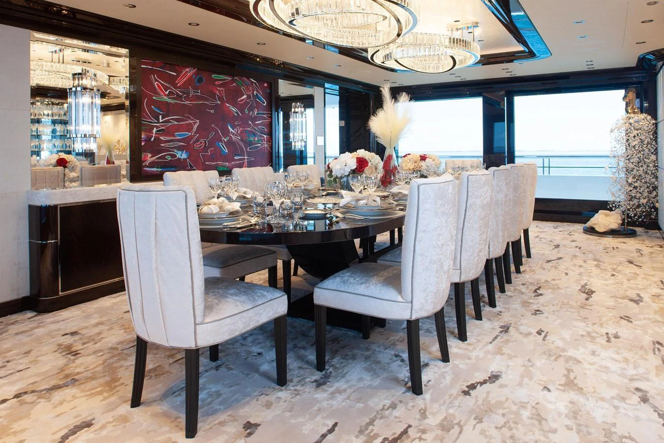 The yacht's dining area features an elegant table setting with plush seating and modern decor. aboard BOARDWALK V Yacht for Sale