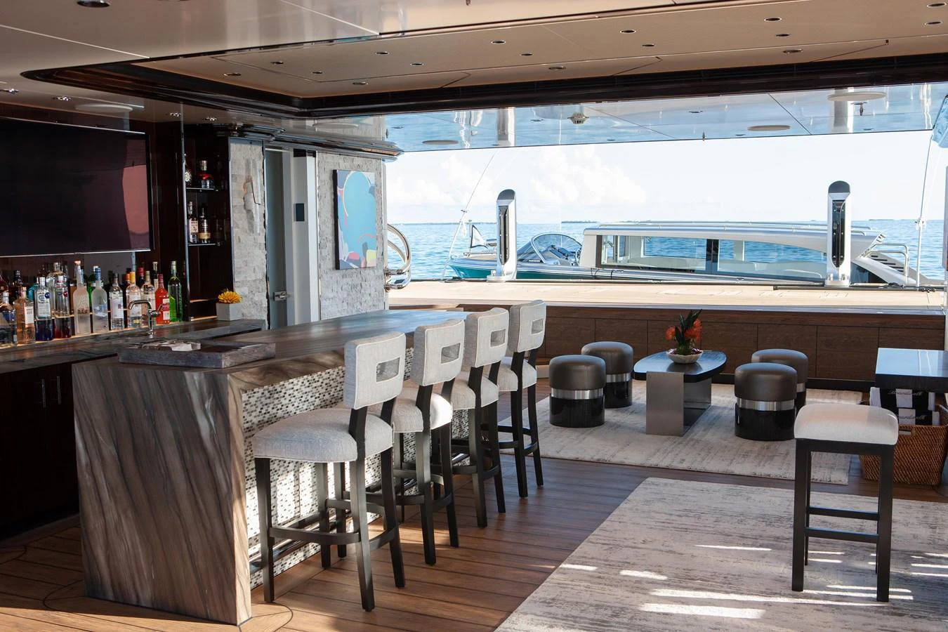 The yacht's bar area offers a luxurious setting with a well-stocked bar and comfortable seating, perfect for entertaining guests. aboard BOARDWALK V Yacht for Sale