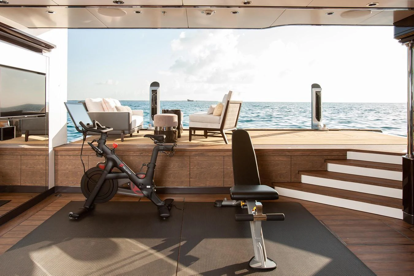 This yacht features a well-equipped gym with a stunning ocean view. aboard BOARDWALK V Yacht for Sale