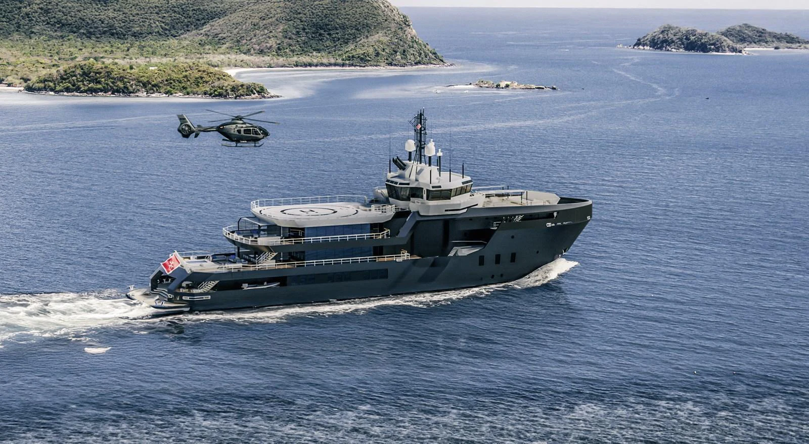 A sleek yacht cruises through serene waters, accompanied by a helicopter overhead. aboard PROJECT MASTER Yacht for Sale