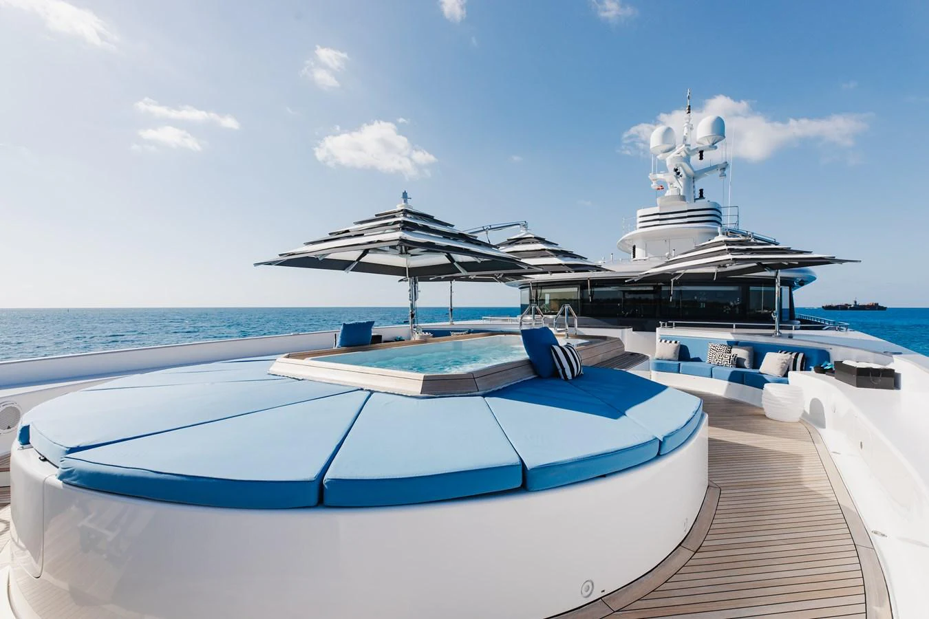 The sundeck features a luxurious jacuzzi surrounded by comfortable sun pads and shaded seating areas. aboard ETERNITY Yacht for Sale