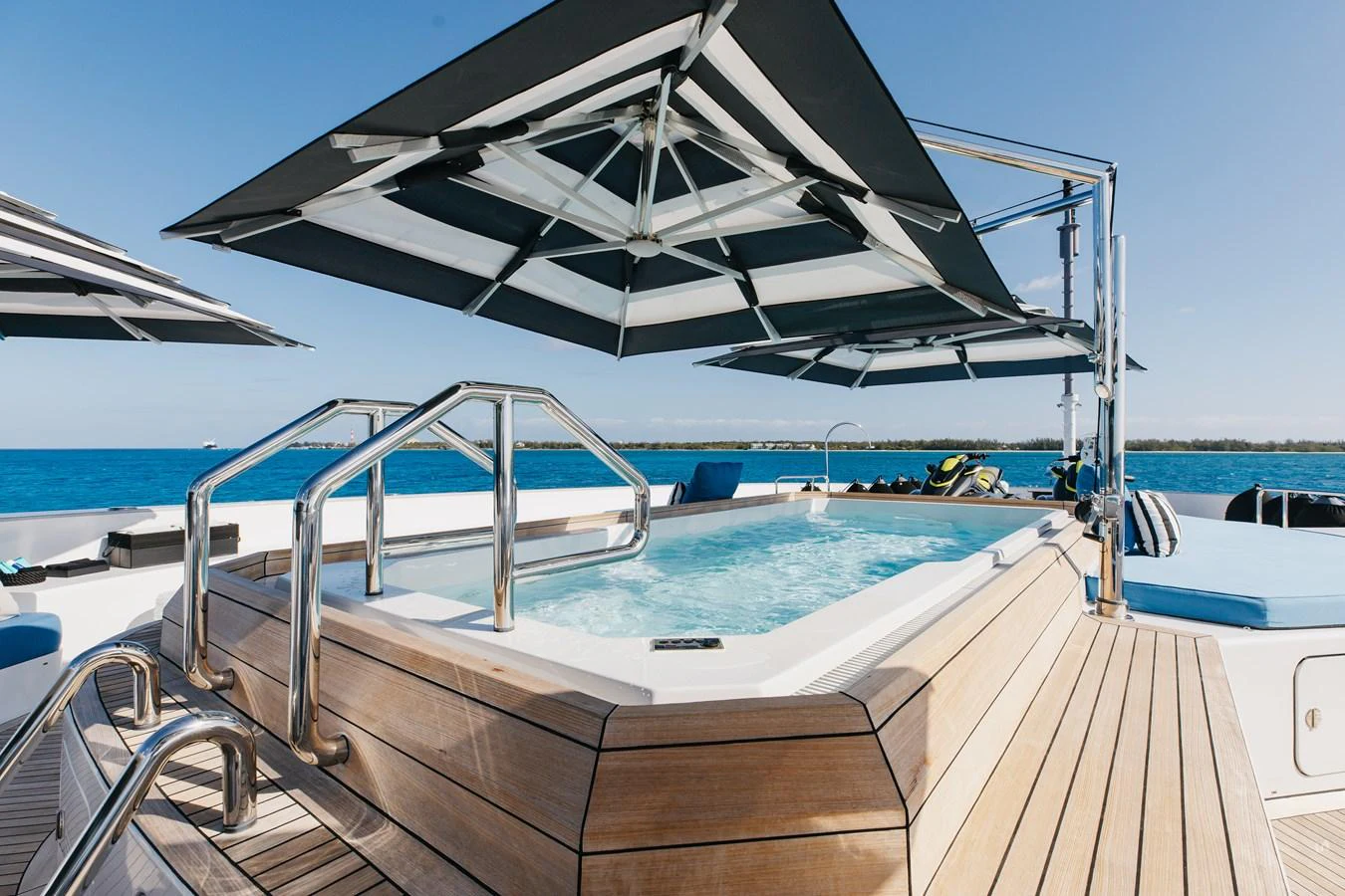 The sundeck features a luxurious jacuzzi with ample seating and shade for relaxation. aboard ETERNITY Yacht for Sale