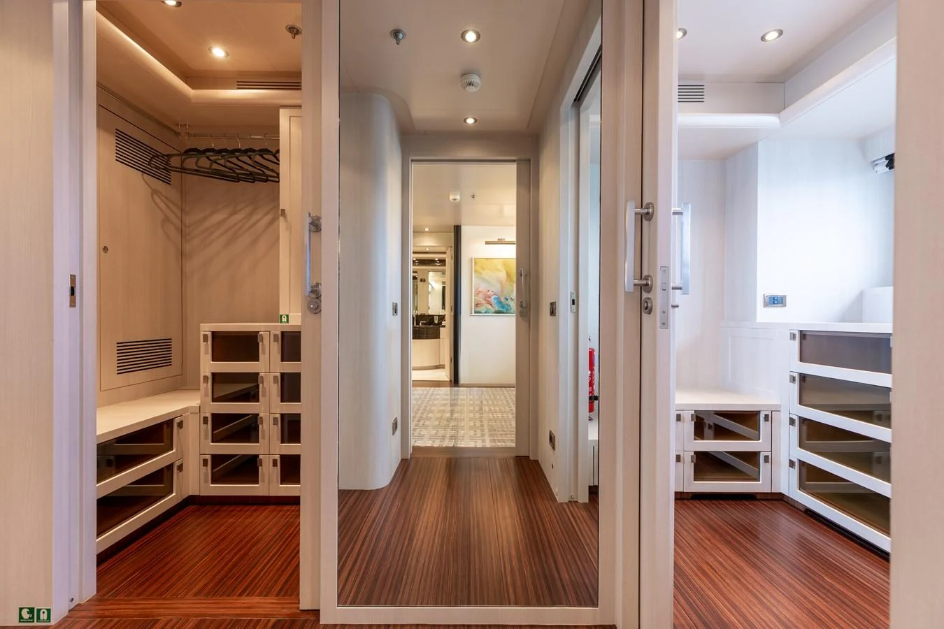 The yacht features a spacious and well-lit walk-in closet with ample storage and elegant wooden flooring. aboard ETERNITY Yacht for Sale