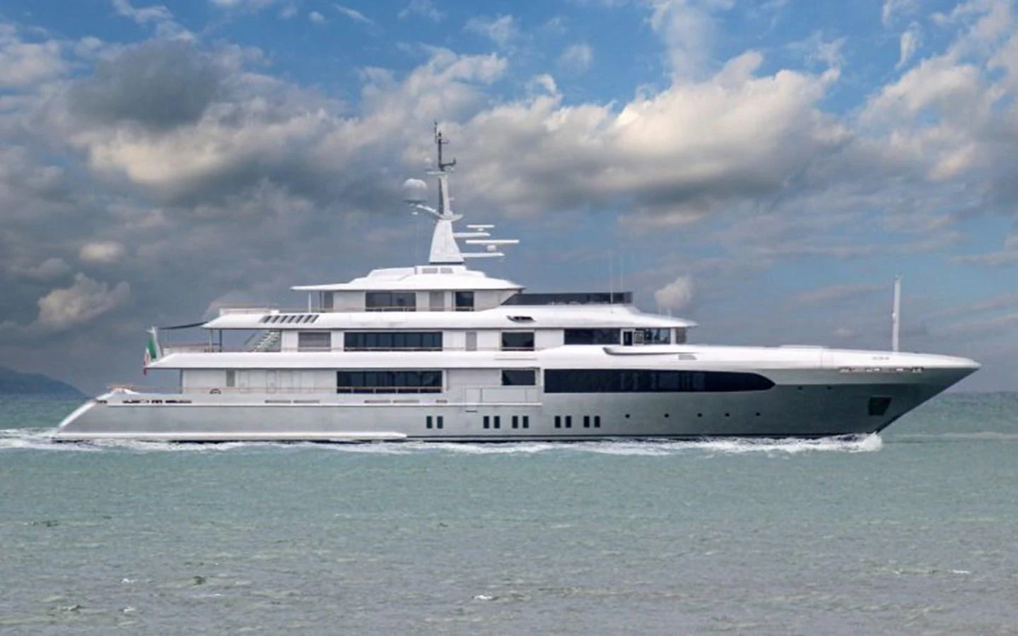 A sleek and modern yacht glides gracefully on calm waters under a partly cloudy sky. aboard REGINA D'ITALIA Yacht for Sale