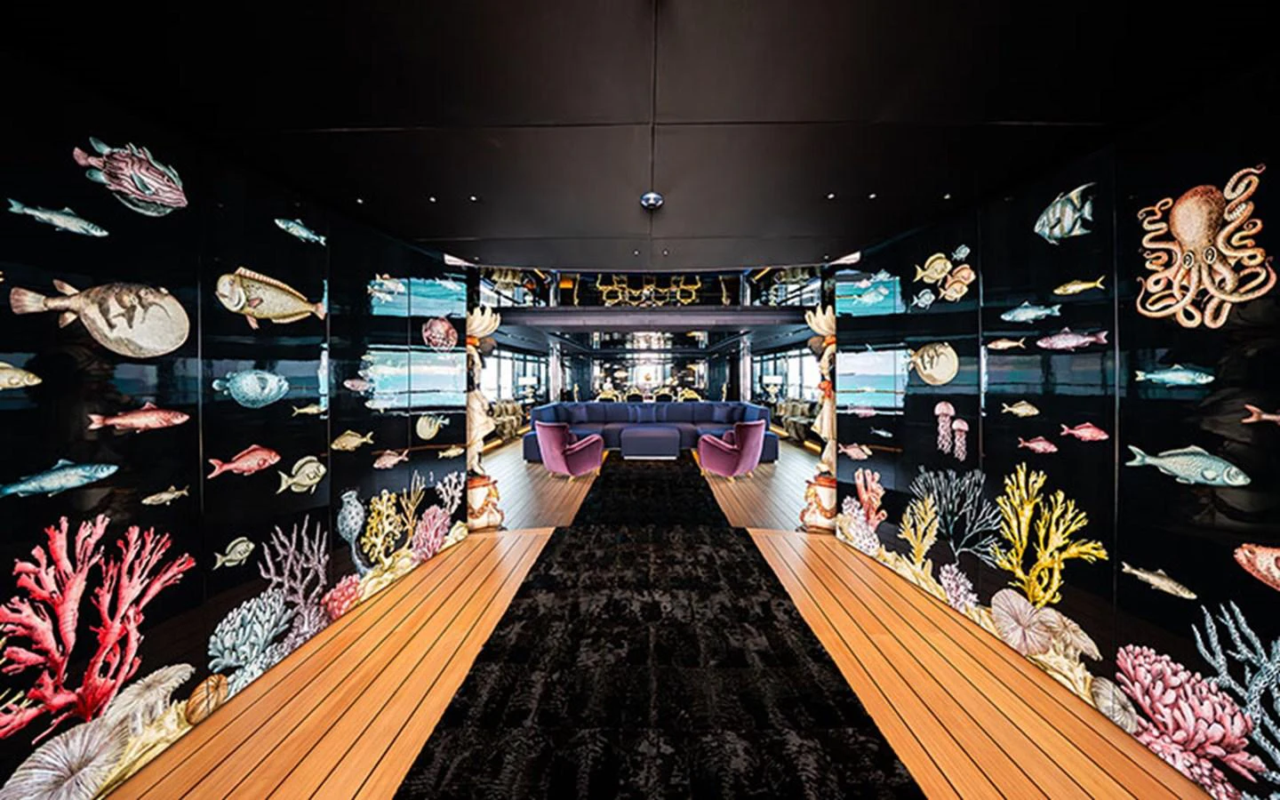 The yacht's interior features a stunning hallway adorned with vibrant marine life artwork, leading to a luxurious lounge area. aboard REGINA D'ITALIA Yacht for Sale