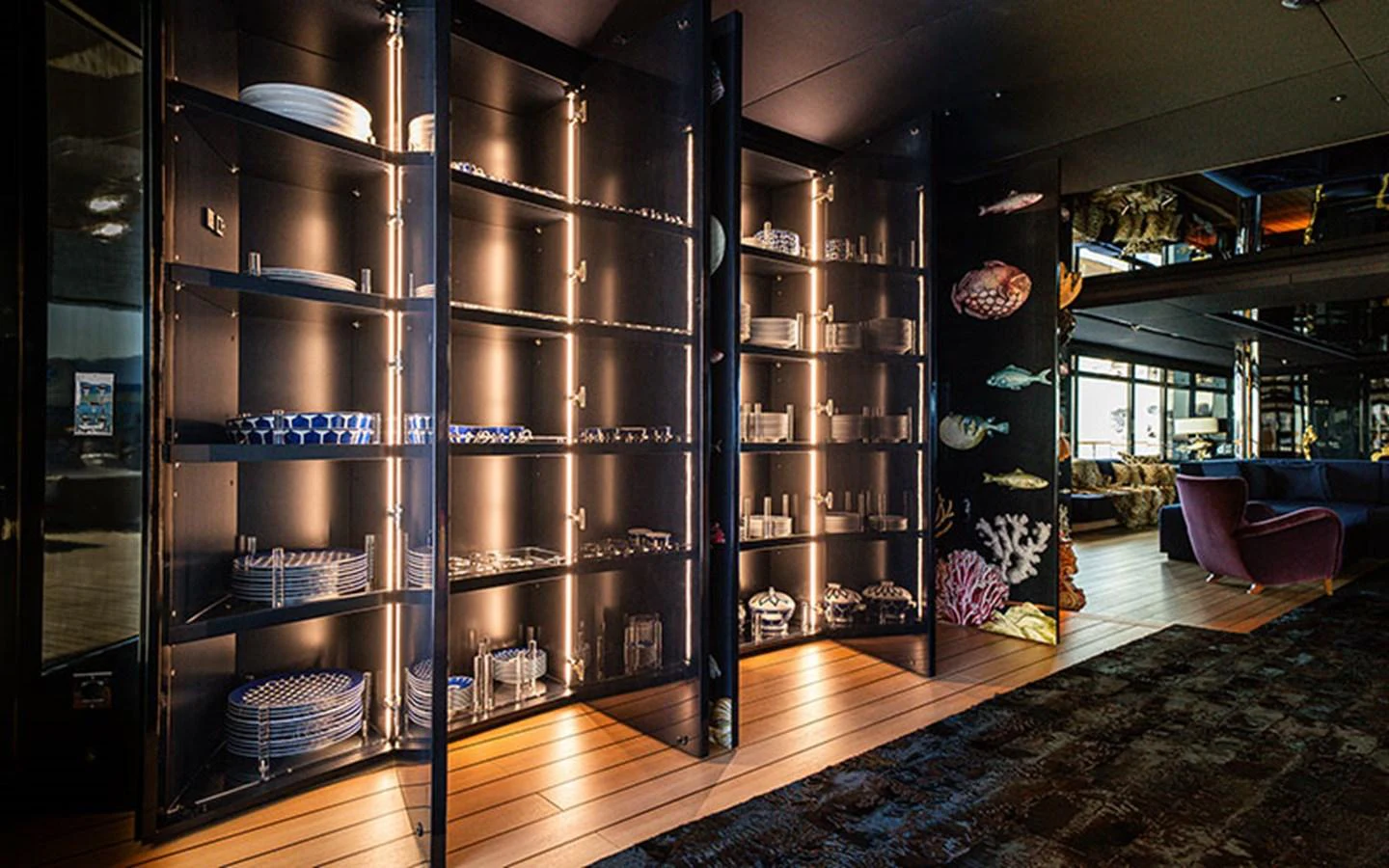 The yacht's interior features a beautifully lit display cabinet showcasing elegant tableware. aboard REGINA D'ITALIA Yacht for Sale