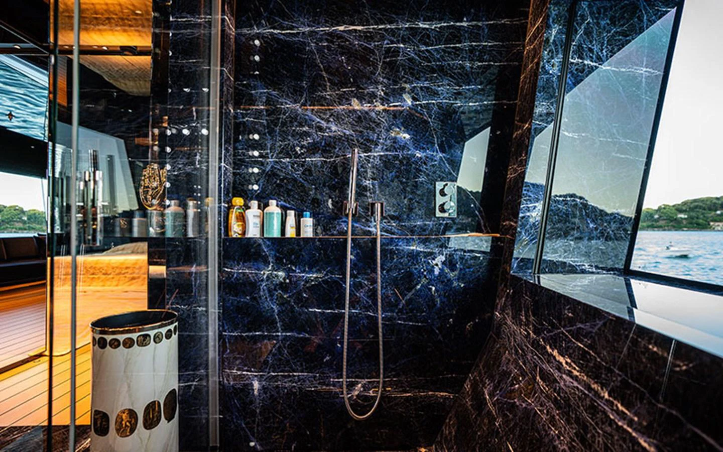 The yacht's bathroom features luxurious dark marble walls and a sleek modern design. aboard REGINA D'ITALIA Yacht for Sale