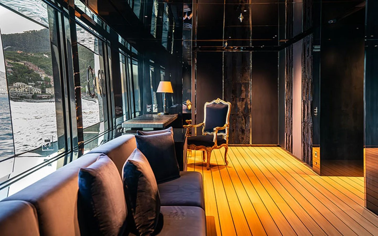 The yacht's interior features a luxurious seating area with elegant furnishings and a stunning view of the sea. aboard REGINA D'ITALIA Yacht for Sale