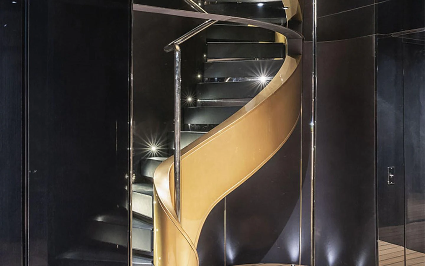 A sleek and modern spiral staircase with elegant lighting. aboard REGINA D'ITALIA Yacht for Sale