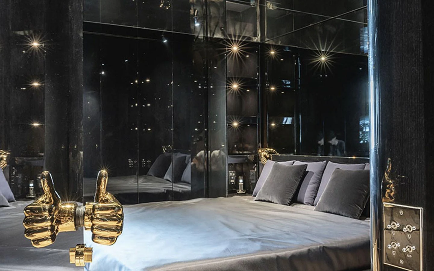 A luxurious stateroom featuring a modern design with reflective surfaces and unique golden decor elements. aboard REGINA D'ITALIA Yacht for Sale