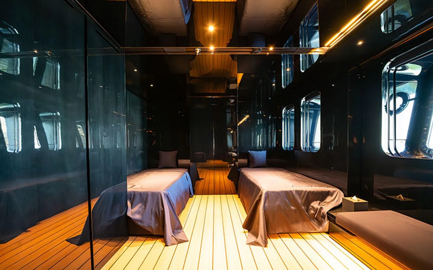 A sleek and modern yacht cabin with twin beds and reflective surfaces. aboard REGINA D'ITALIA Yacht for Sale