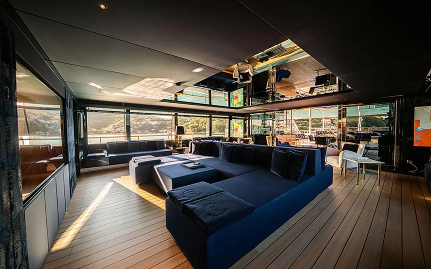 The spacious salon features luxurious seating with panoramic views and modern decor. aboard REGINA D'ITALIA Yacht for Sale