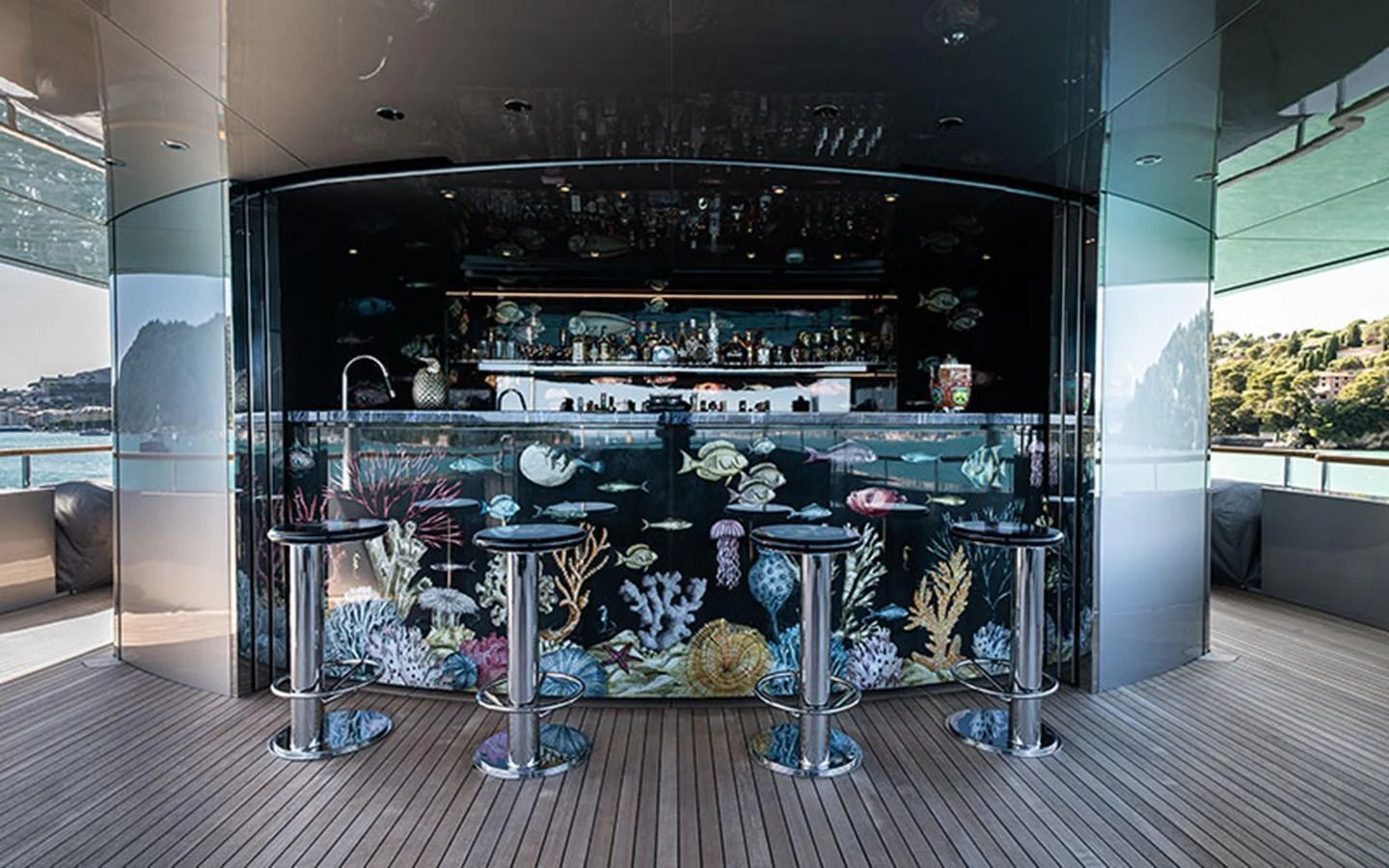 This luxurious yacht features a stunning bar area with an aquatic-themed design, perfect for entertaining guests. aboard REGINA D'ITALIA Yacht for Sale