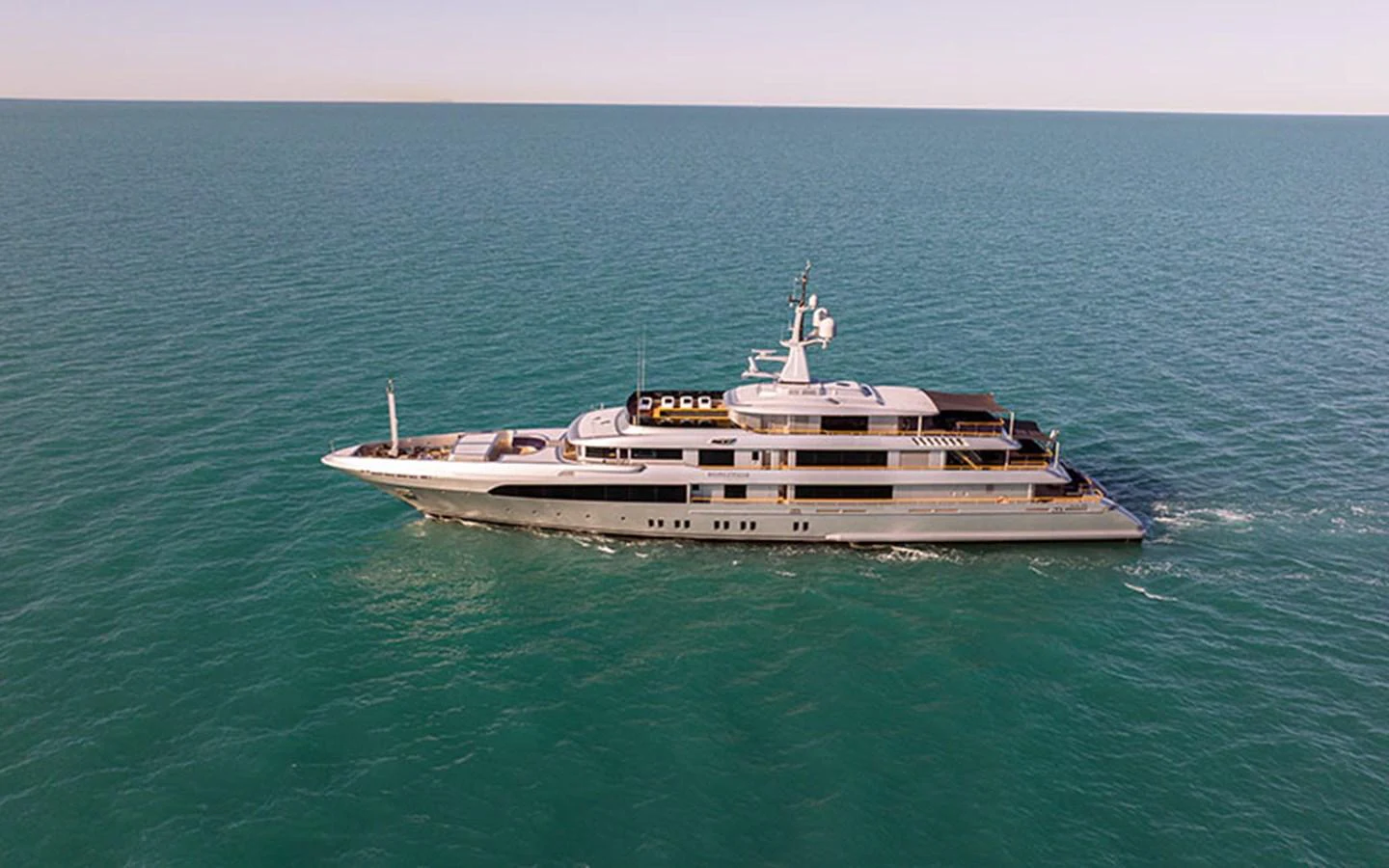 A sleek and elegant yacht cruises smoothly on calm waters under a clear sky. aboard REGINA D'ITALIA Yacht for Sale