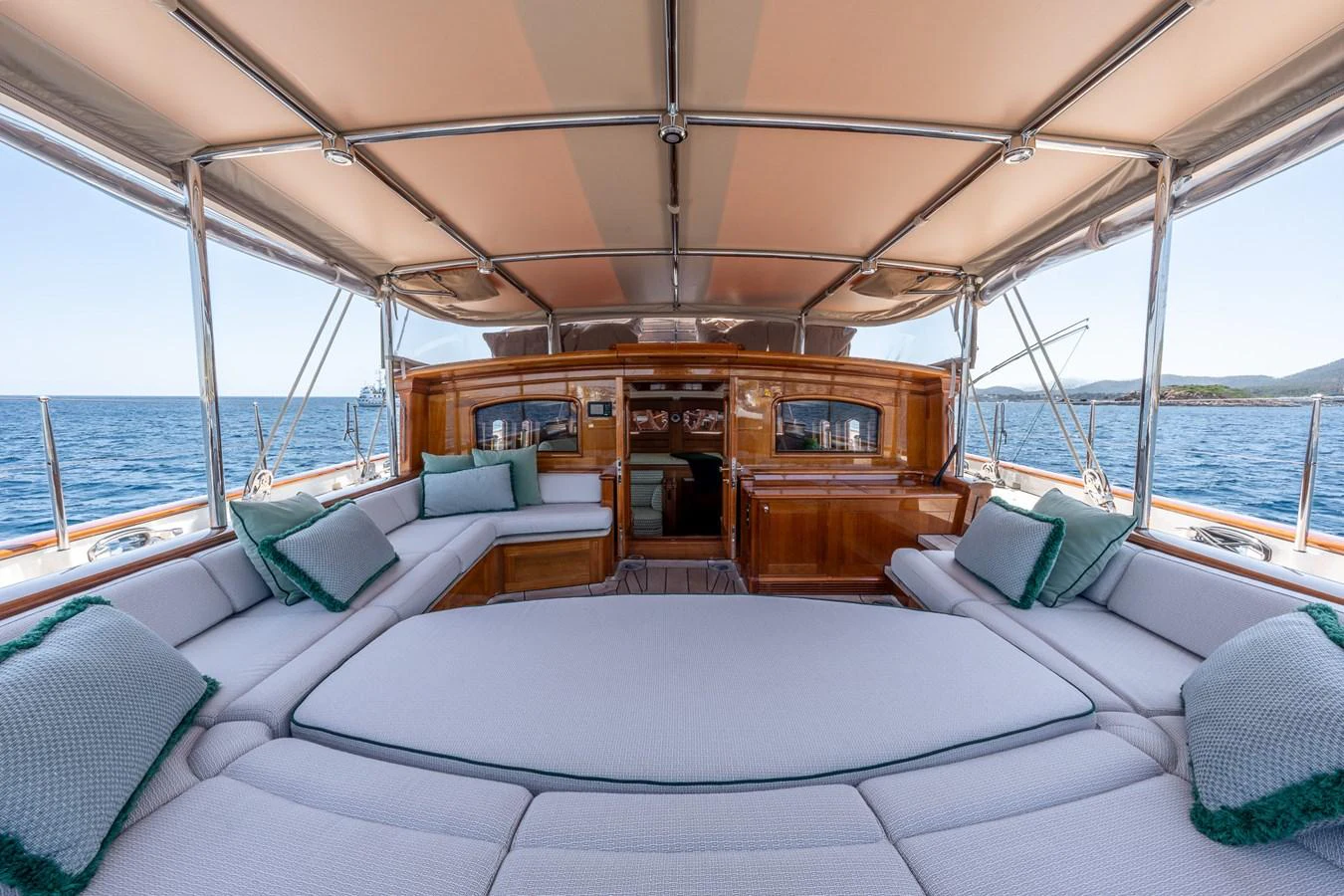 The aft deck features luxurious seating with plush cushions, offering a perfect spot to relax and enjoy the sea view. aboard ATHOS Yacht for Sale