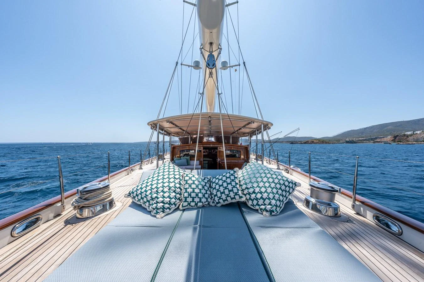 The foredeck of this yacht features spacious sun pads and stylish cushions, perfect for relaxation while cruising. aboard ATHOS Yacht for Sale