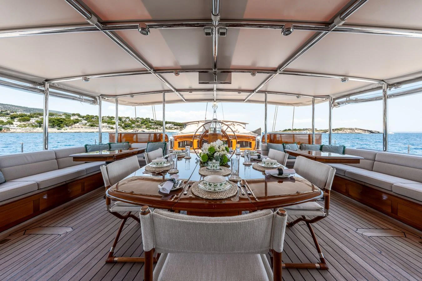 The aft deck features an elegant dining area with a stunning view of the sea. aboard ATHOS Yacht for Sale