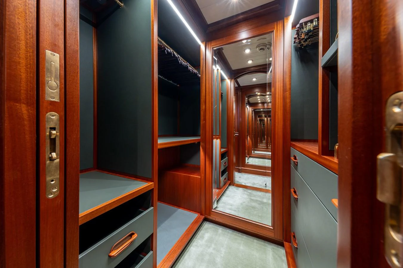 A luxurious walk-in closet with rich wood finishes and ample storage space. aboard ATHOS Yacht for Sale