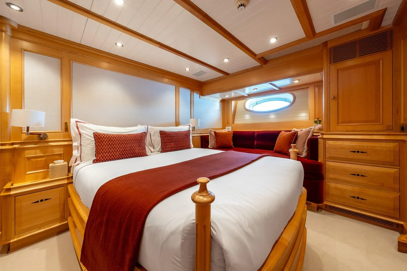 The master stateroom features a luxurious bed with rich wood finishes and elegant decor. aboard ATHOS Yacht for Sale