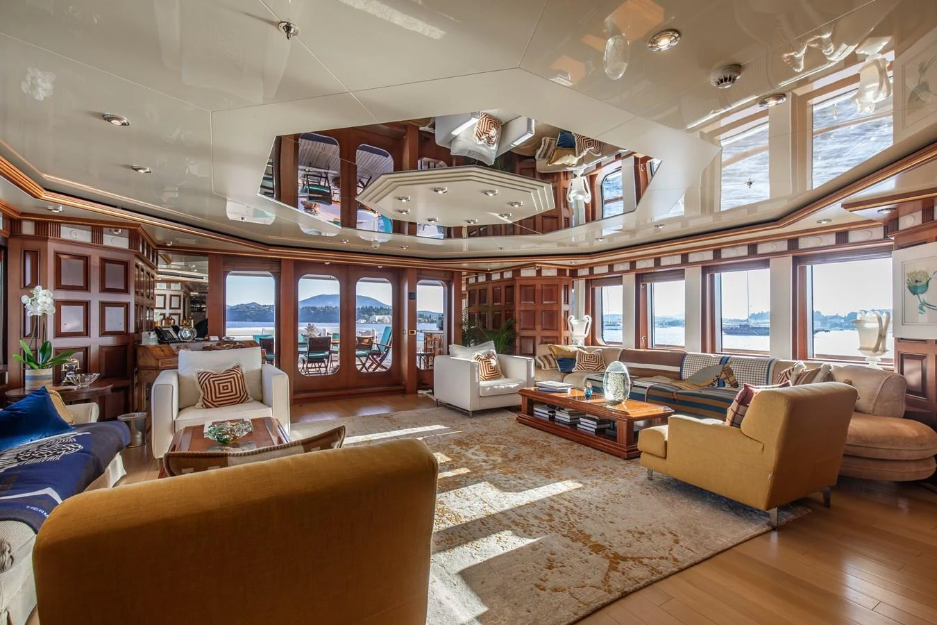 The spacious salon features elegant furnishings and panoramic windows offering stunning views. aboard LADY MARINA Yacht for Sale