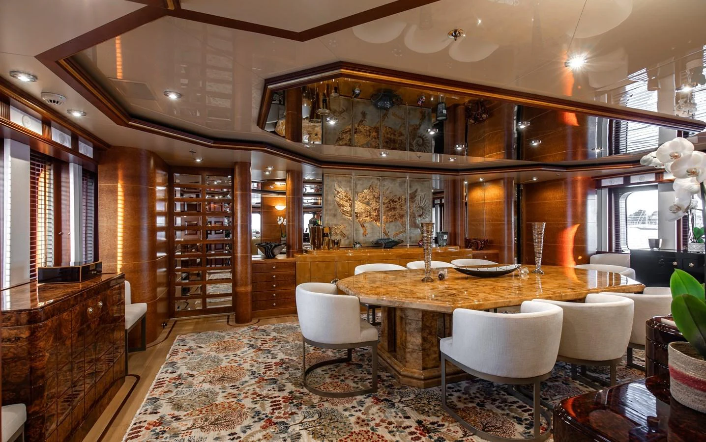 The yacht's dining area features luxurious wood finishes, plush seating, and elegant decor. aboard LADY MARINA Yacht for Sale