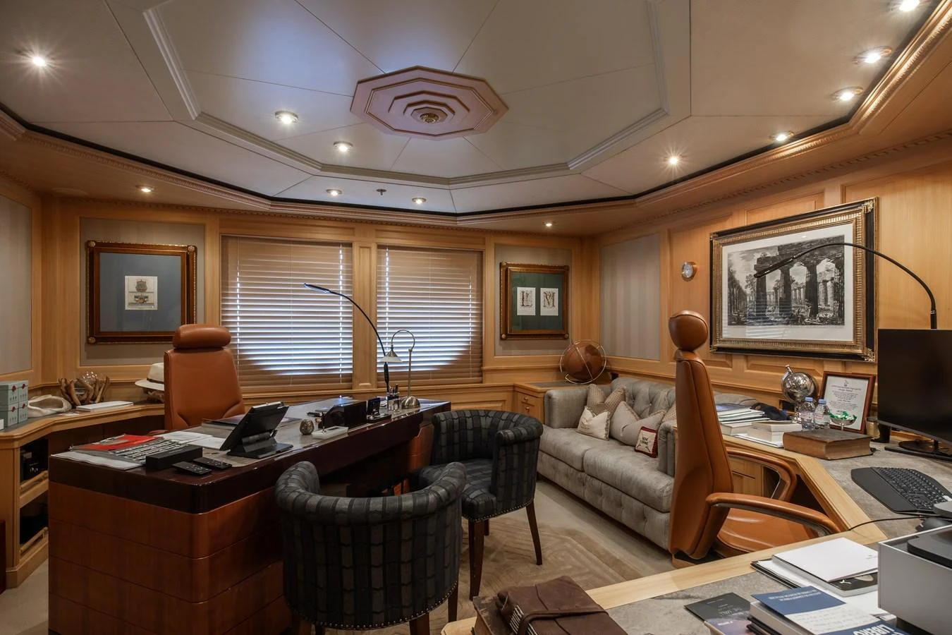 The yacht's office features elegant wood paneling, a comfortable seating area, and modern amenities for a productive workspace. aboard LADY MARINA Yacht for Sale
