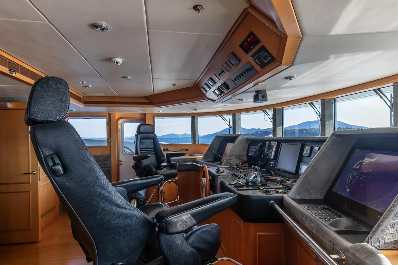 The helm station offers a commanding view with state-of-the-art navigation equipment and luxurious seating. aboard LADY MARINA Yacht for Sale
