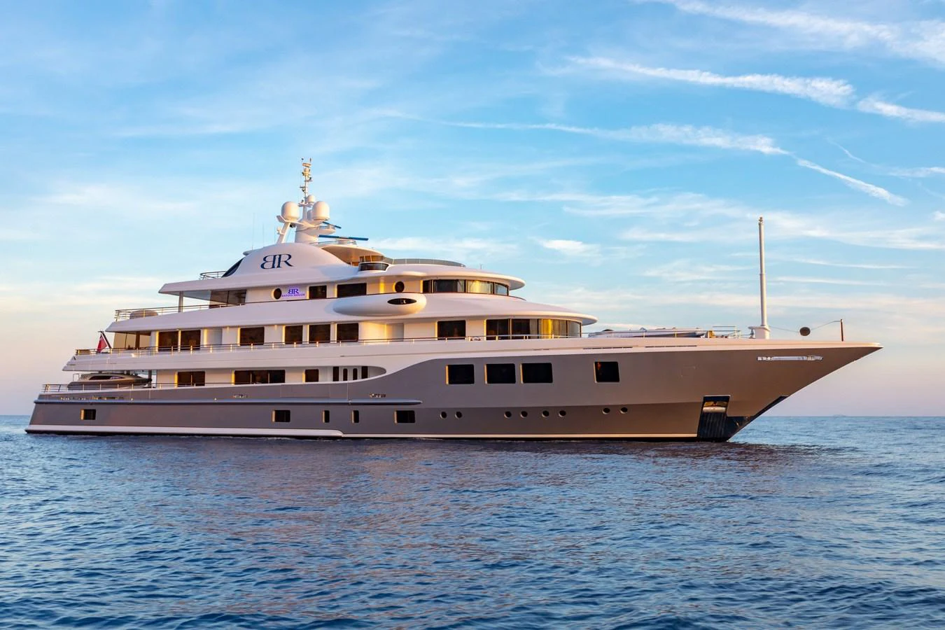 A luxurious yacht cruises elegantly on calm waters under a serene sky. aboard BATON ROUGE Yacht for Sale