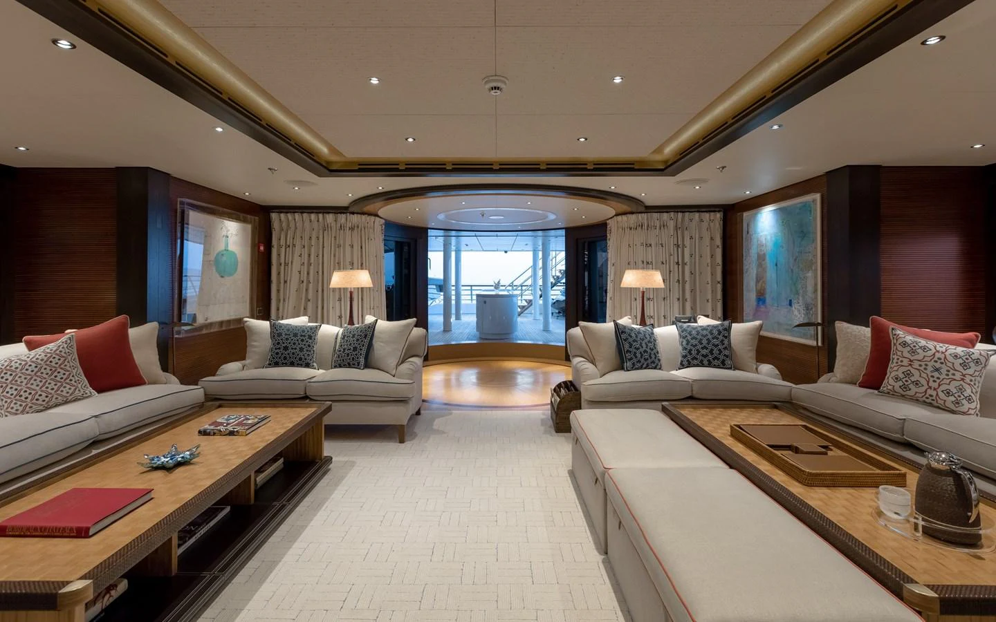The spacious salon features elegant seating and a serene ambiance with a view of the aft deck. aboard BATON ROUGE Yacht for Sale