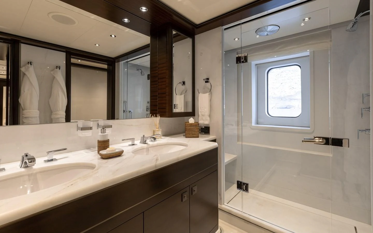 The yacht's bathroom features a spacious shower and dual sinks with elegant fixtures. aboard BATON ROUGE Yacht for Sale