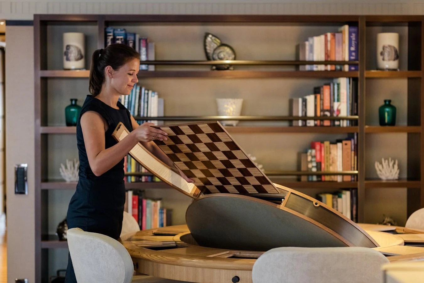 A luxurious yacht library featuring a chessboard table and elegant bookshelves. aboard BATON ROUGE Yacht for Sale