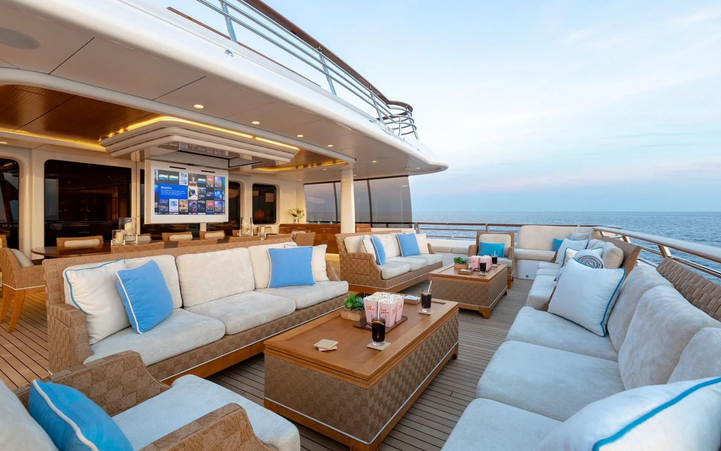 The aft deck features a luxurious outdoor lounge area with plush seating and a large TV, perfect for relaxation and entertainment. aboard BATON ROUGE Yacht for Sale