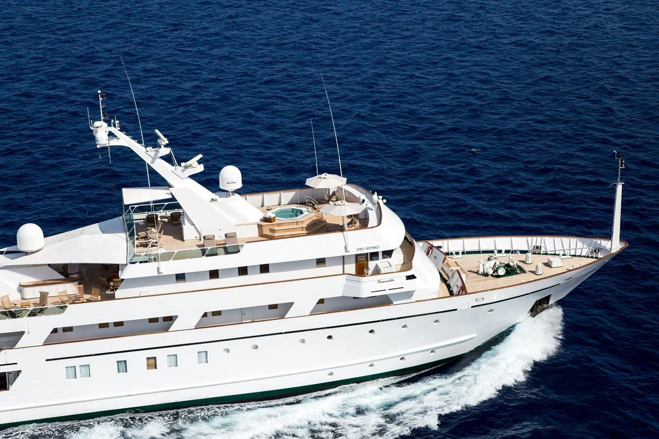 A luxurious yacht cruises through the open sea, showcasing its elegant design and spacious decks. aboard ESMERALDA Yacht for Sale