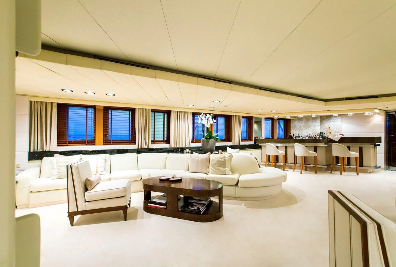 The spacious salon features elegant seating and a stylish bar area, perfect for relaxation and entertainment. aboard ESMERALDA Yacht for Sale