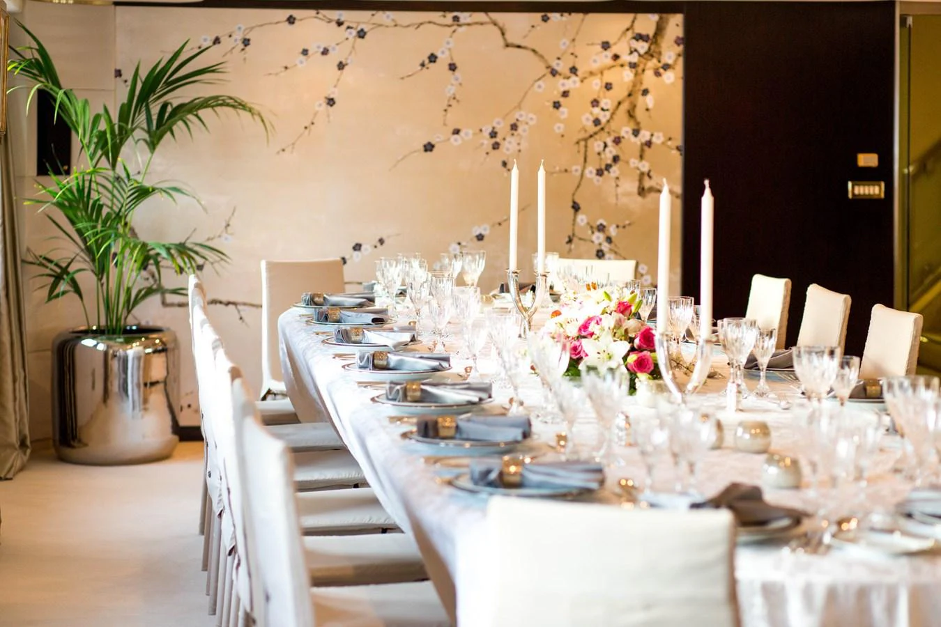The elegant dining area features a beautifully set table with fine china and a floral centerpiece, perfect for a luxurious meal. aboard ESMERALDA Yacht for Sale