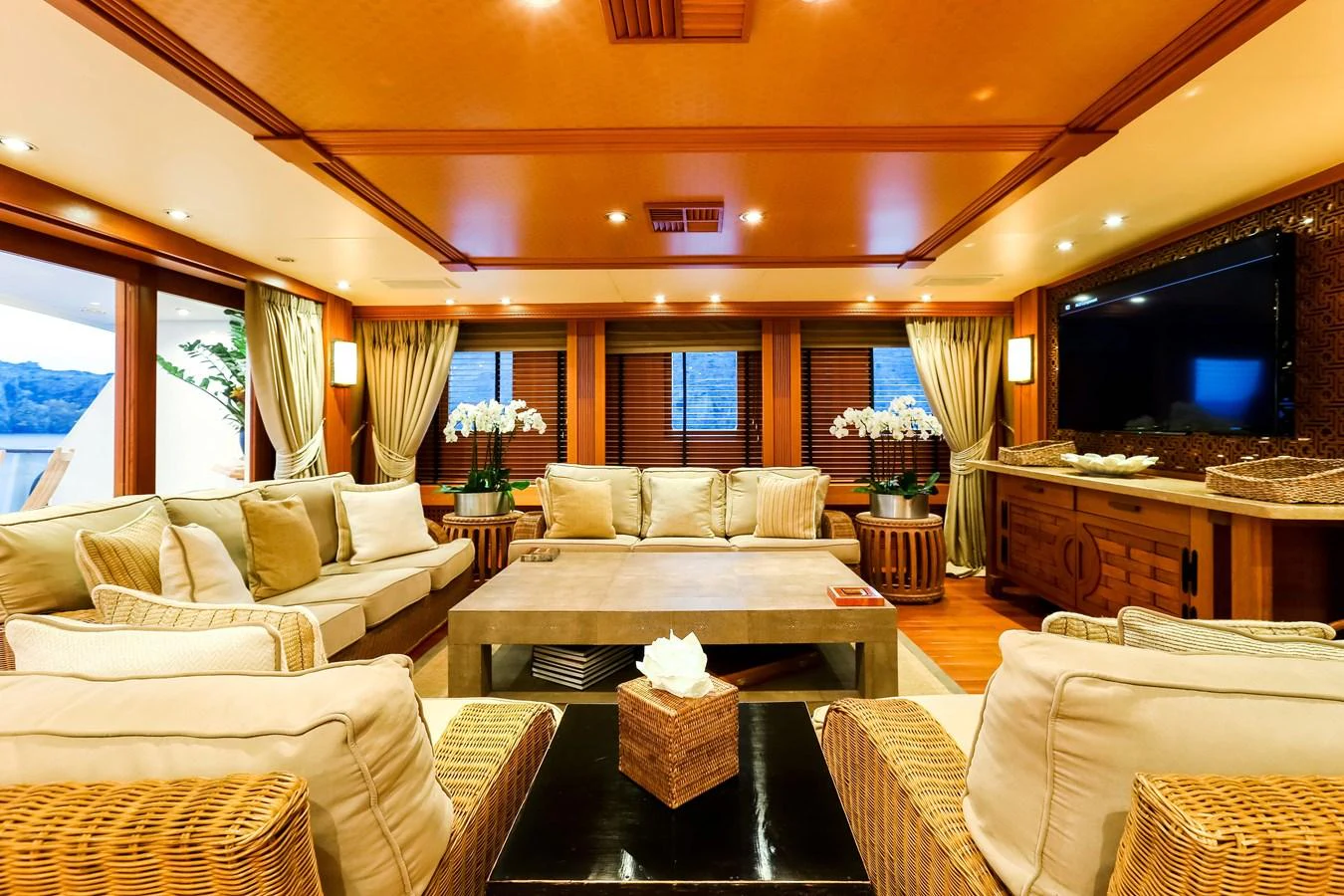 The salon features plush seating, warm lighting, and elegant decor, creating a cozy and inviting atmosphere. aboard ESMERALDA Yacht for Sale