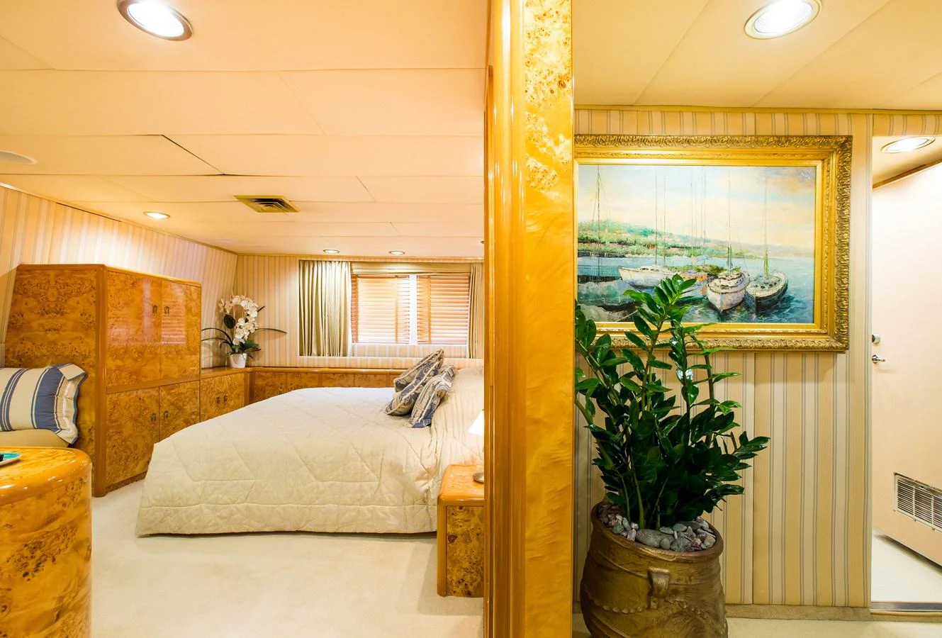 A luxurious stateroom featuring a comfortable bed and elegant decor. aboard ESMERALDA Yacht for Sale