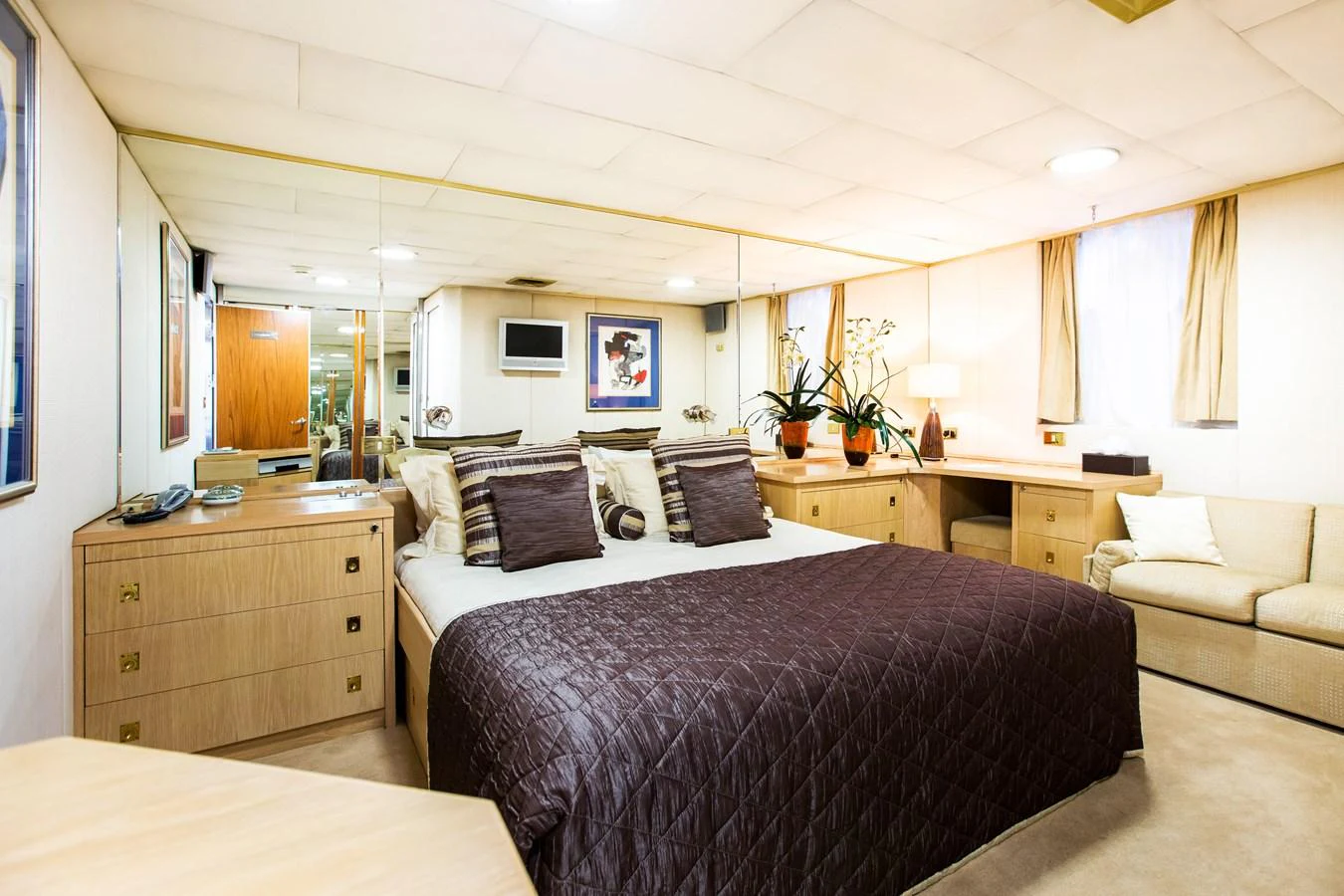 The master stateroom features a luxurious bed with elegant bedding and ample storage space. aboard ESMERALDA Yacht for Sale