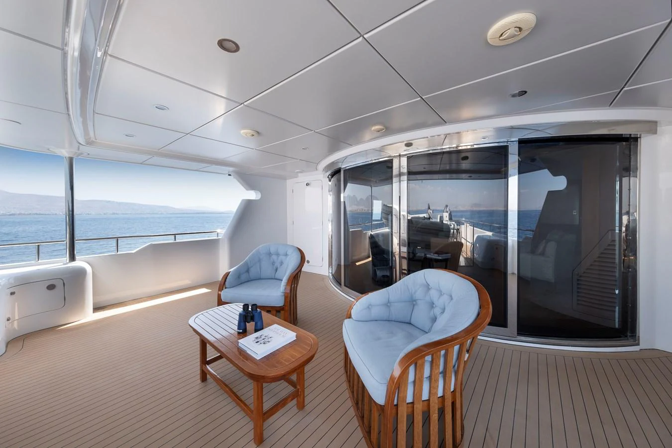 The aft deck offers a spacious and inviting area with comfortable seating and a beautiful view of the sea. aboard HAPPY DOLPHIN II Yacht for Sale