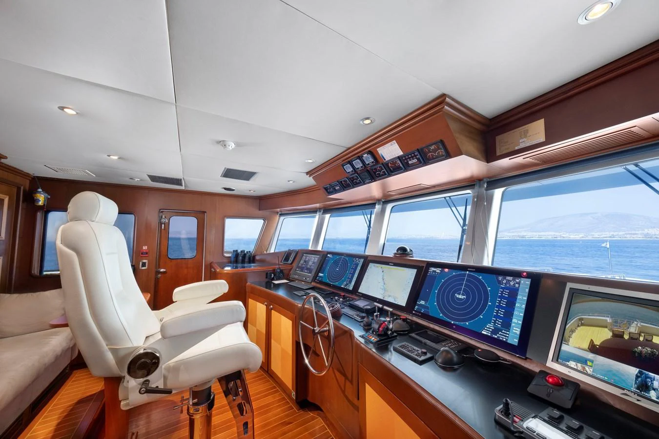 The helm station offers a commanding view with state-of-the-art navigation equipment and luxurious seating. aboard HAPPY DOLPHIN II Yacht for Sale