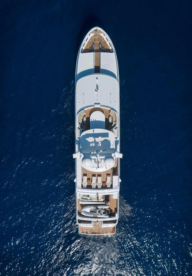A stunning aerial view of a luxurious yacht cruising through deep blue waters. aboard HAPPY DOLPHIN II Yacht for Sale