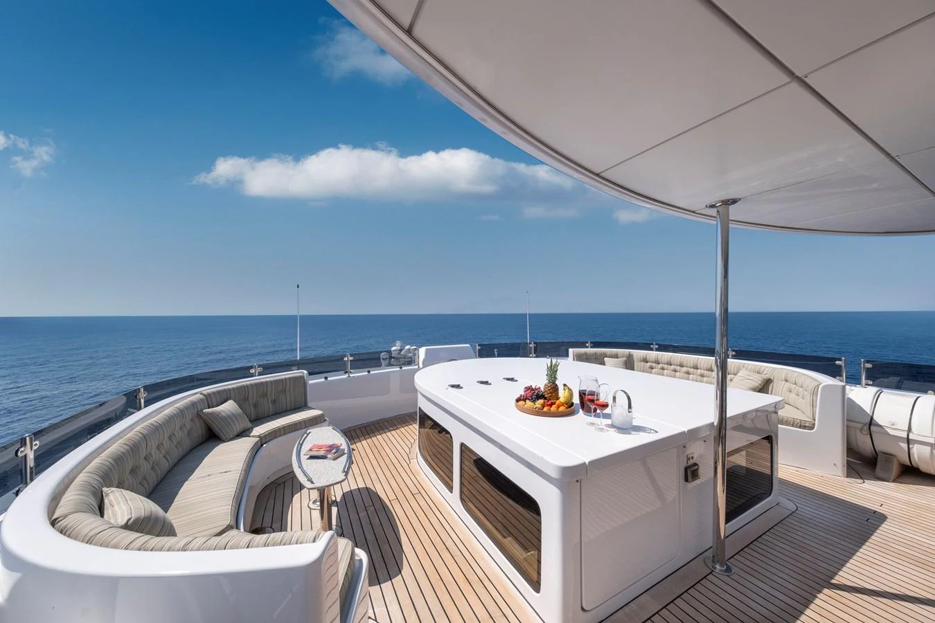 The sundeck offers a luxurious space with comfortable seating and a central bar area, perfect for relaxation and entertainment. aboard HAPPY DOLPHIN II Yacht for Sale