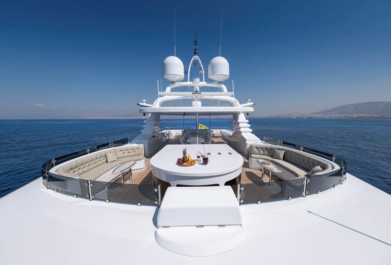 The yacht's sundeck offers a spacious and luxurious area for relaxation and dining with panoramic ocean views. aboard HAPPY DOLPHIN II Yacht for Sale