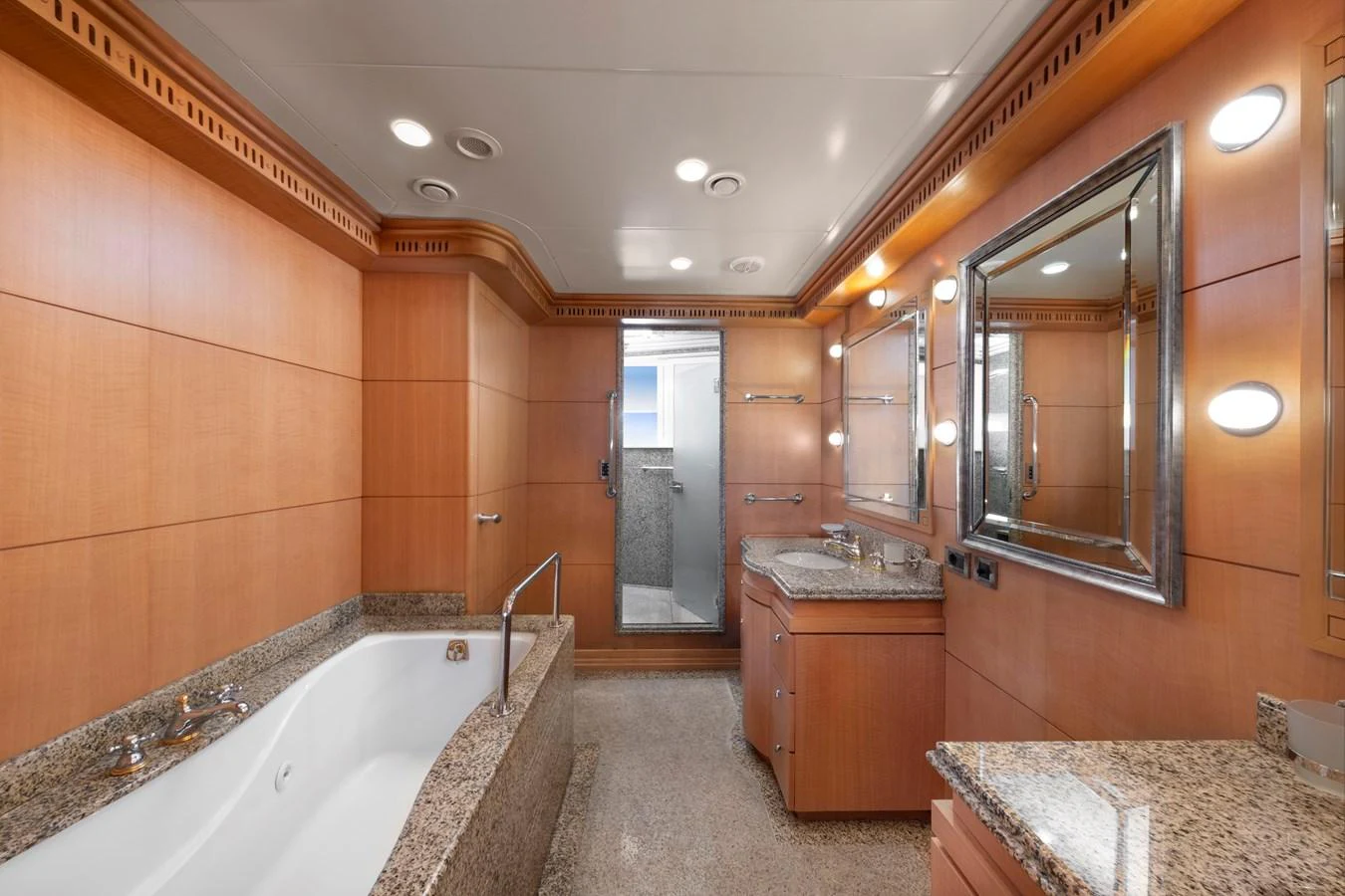 The yacht's bathroom features elegant wood paneling and luxurious granite countertops. aboard HAPPY DOLPHIN II Yacht for Sale