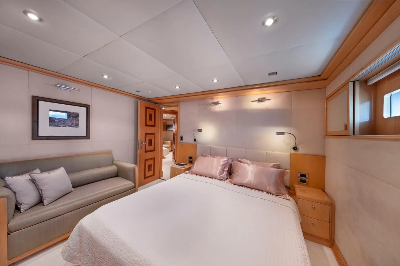The stateroom features a luxurious bed with plush pillows and a cozy seating area. aboard HAPPY DOLPHIN II Yacht for Sale
